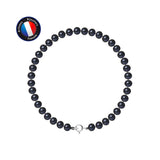 Le bracelet NOELYSE de Perlinea est composé de perles noires de 5/6 mm et d'un fermoir à anneau en argent 925, disposés en cercle sur un fond blanc. Une étiquette bleue dans le coin supérieur gauche indique Artisan Bijoutier Français.