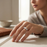Bague en argent 925 avec perle de culture blanche et oxydes, portée à la main.