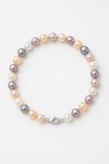 Bracelet argent 925 orné de perles multicolores pastel avec fermoir anneau.
