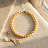 Bracelet perles d'eau douce dorées sur argent 925 avec fermoir mousqueton doré.