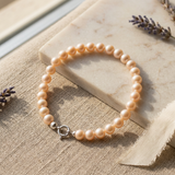 Bracelet perles roses en or blanc 9 carats avec fermoir anneau ressort argenté.
