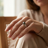 Bague en or blanc 9 carats sertie d'une perle de Tahiti grise portée à l'annulaire.