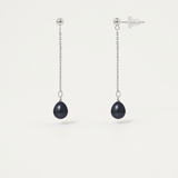 Boucles d'oreilles pendantes or blanc 9 carats avec perles noires sur chaîne fine.