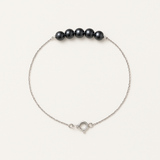 Bracelet or blanc 9 carats avec cinq perles noires sur chaîne fine et fermoir anneau.